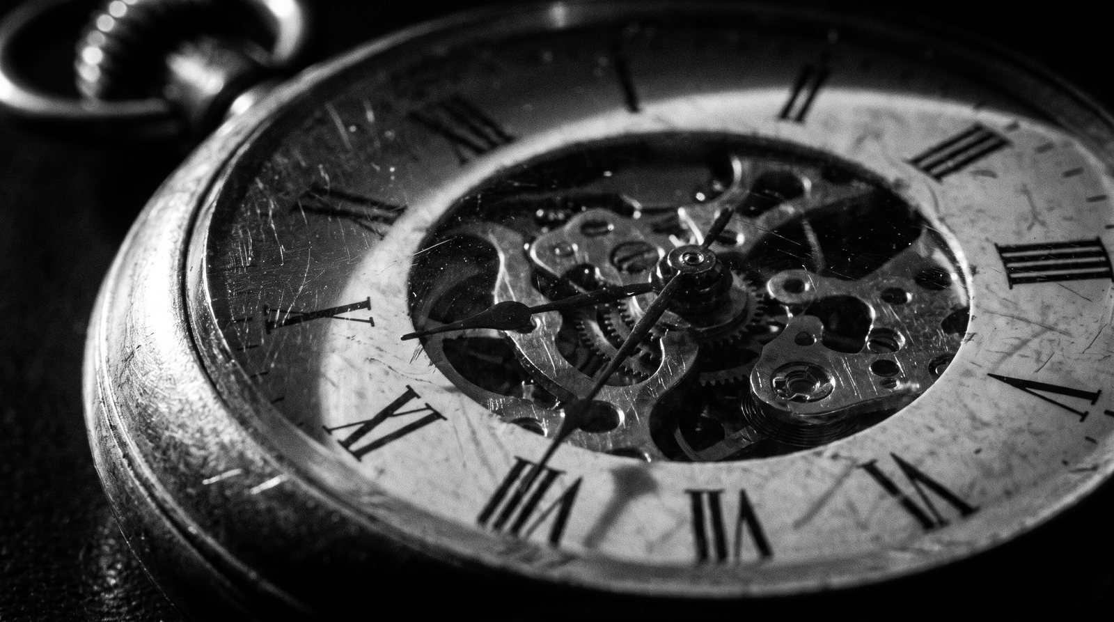 An extreme close-up of a mechanical stopwatch face in dramatic side light